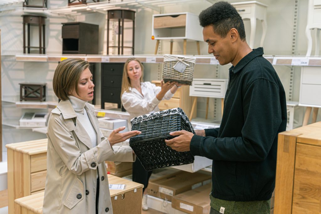 Customers and staff engaging with home goods products in a retail environment. sales training